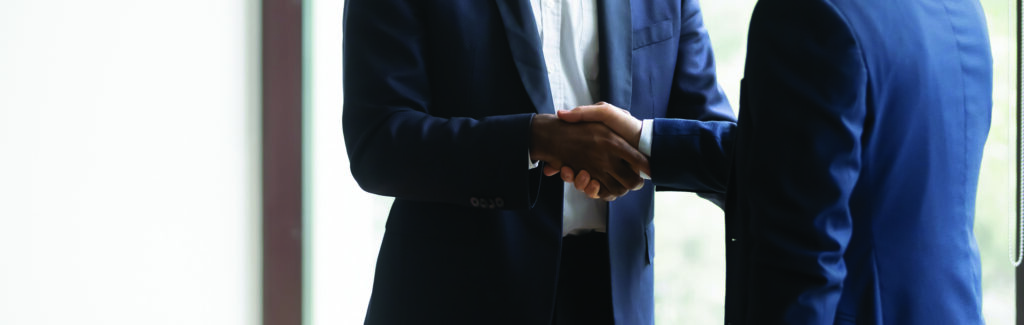 Two men shaking hands in business suits